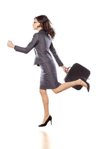 Excited business woman running and holding a briefcase